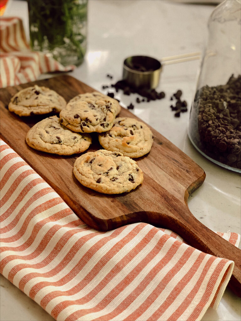 quick and easy chocolate chip cookies on a wooden board in a kitchen with towel